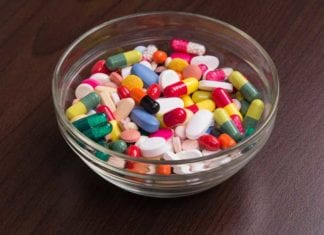 Glass Candy Bowl Filled with Assortment of Antibiotics, Steroids, and Narcotics Available at ER Triage Desk bowl of pills