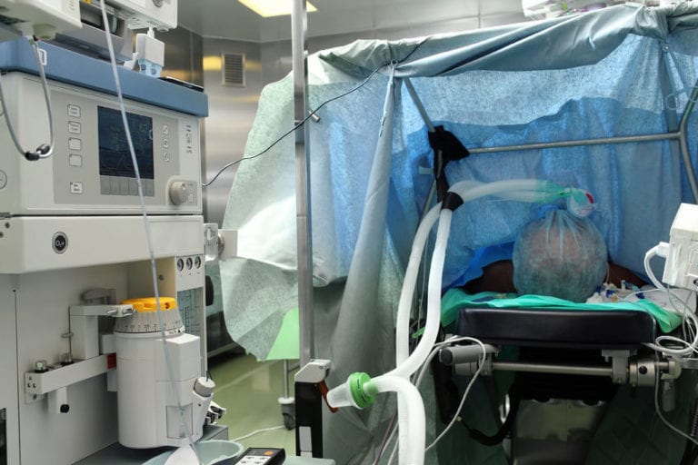 Anesthesiologist Behind Drape Plays Peakaboo with Surgeon