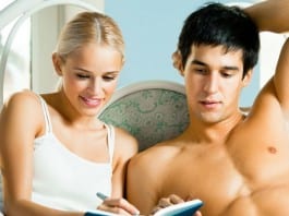 Hospital Administrator Gives Partner Post-Coital Satisfaction Survey Out Of Habit couple in bed filling out survey