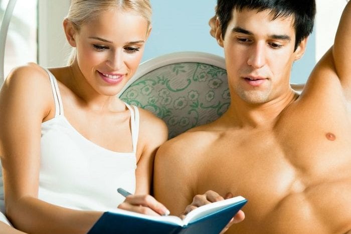 couple in bed filling out survey