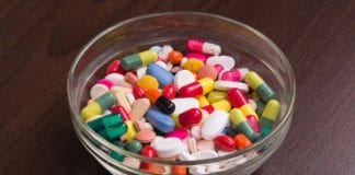 Glass Candy Bowl Filled with Assortment of Antibiotics, Steroids, and Narcotics Available at ER Triage Desk bowl of pills