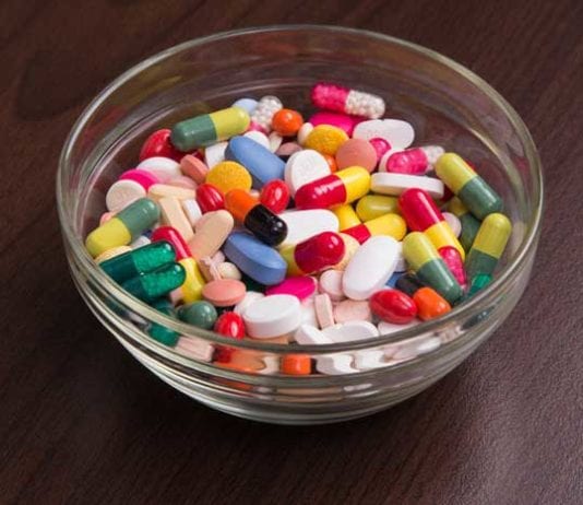 Glass Candy Bowl Filled with Assortment of Antibiotics, Steroids, and Narcotics Available at ER Triage Desk bowl of pills