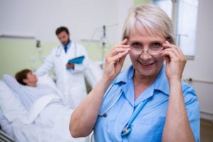 62473383 - portrait of smiling nurse wearing spectacle in hospital room